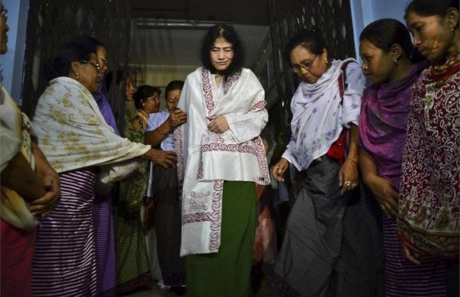 In this Wednesday, Aug. 20, 2014 file photo, Irom Sharmila, center, walks out of a security ward after her release in Porompal district, in Imphal, India. T