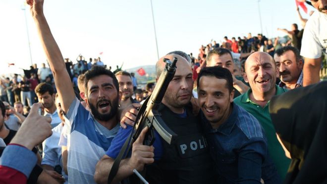 Crowds celebrate taking over a military position on the Bosphorus bridge