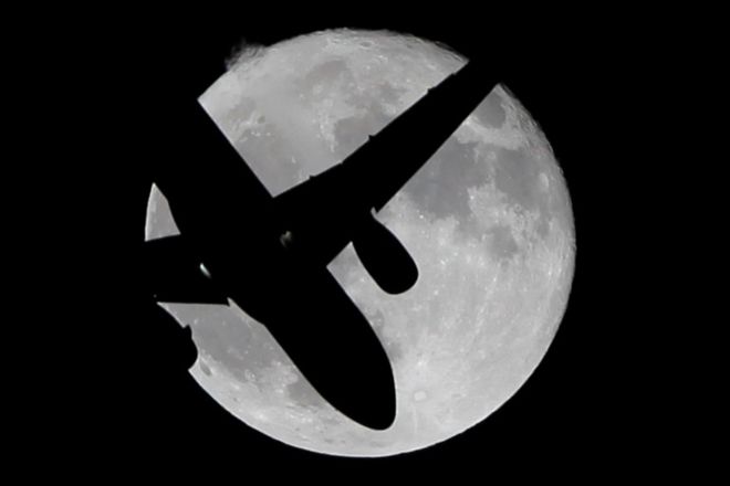 Aircraft in front of moon