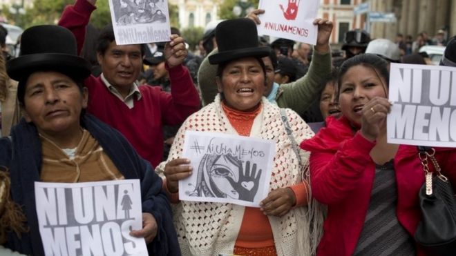 Aymara women and activists shout slogans and hold signs that read in Spanish "not one less" during a march against gender violence in La Paz, Bolivia, Wednesday, Oct 19, 2016