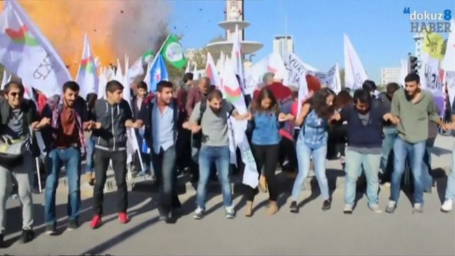 Grab from amateur video showing explosion in background, group of activists in foreground, Ankara (10 October 2015)