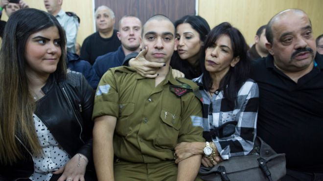 Israeli solider Sgt Elor Azaria sits with his family before hearing the verdict at a military court in Tel Aviv, Israel (4 January 2017)
