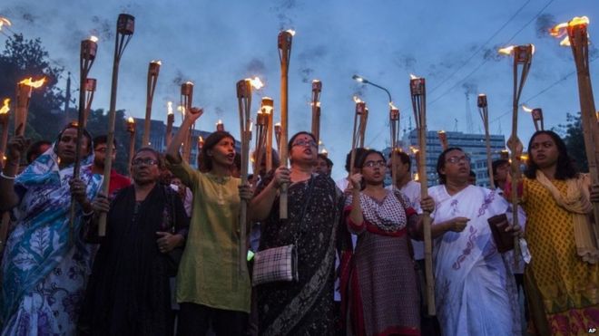 Bangladeshi secular activists participate in a torch rally held to protest against the killing of blogger Niloy Chottopadhay