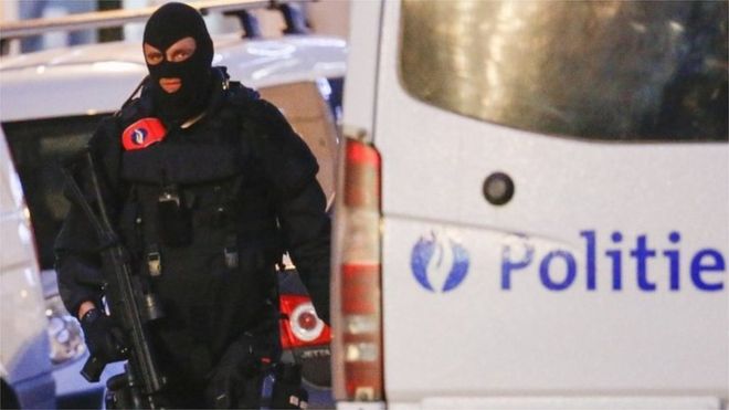 A Belgian special forces police officer patrols a street during a police raid in central Brussels (image from 20 December)