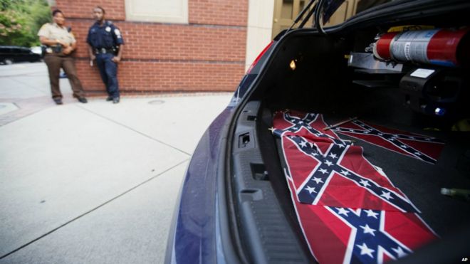 Confederate flags sit in the back of a police car outside Ebenezer Baptist Church in Atlanta - 30 July 2015