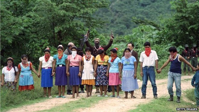 Subcomandante Marcos (centre, rear) stands in front of a group of Zapatista supporters on 7 January, 1996 in La Realidad, Mexico.