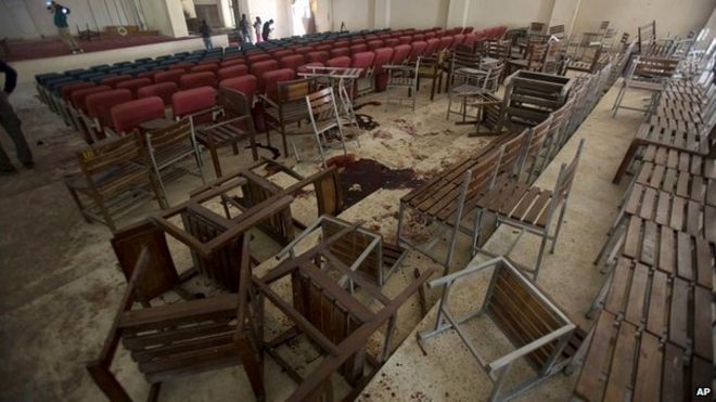 Upturned chairs and blood stains the floor at the Army Public School auditorium the day after Taliban gunmen stormed the school in Peshawar - 17 December 2014