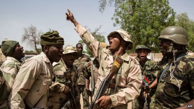 Nigerian troops celebrate after taking over Bama from Boko Haram on 25 March