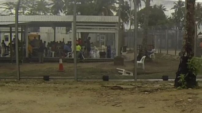 View through fence to an area where detainees are, on Manus Island