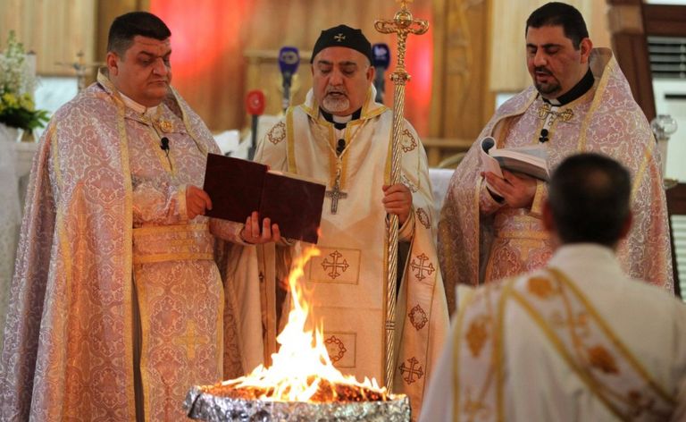 Iraqi Christian priests hold a Christmas mass at the Catholic Church of Our Lady of Deliverance/Salvation (Sayidat al-Nejat), in central Baghdad, on December 24, 2015