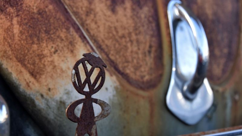 VW logo on rusty Beetle