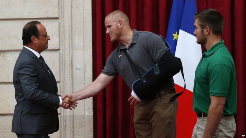 President Hollande shakes the hand of Spencer Stone, as Alek Skarlatos looks on, 24 Aug