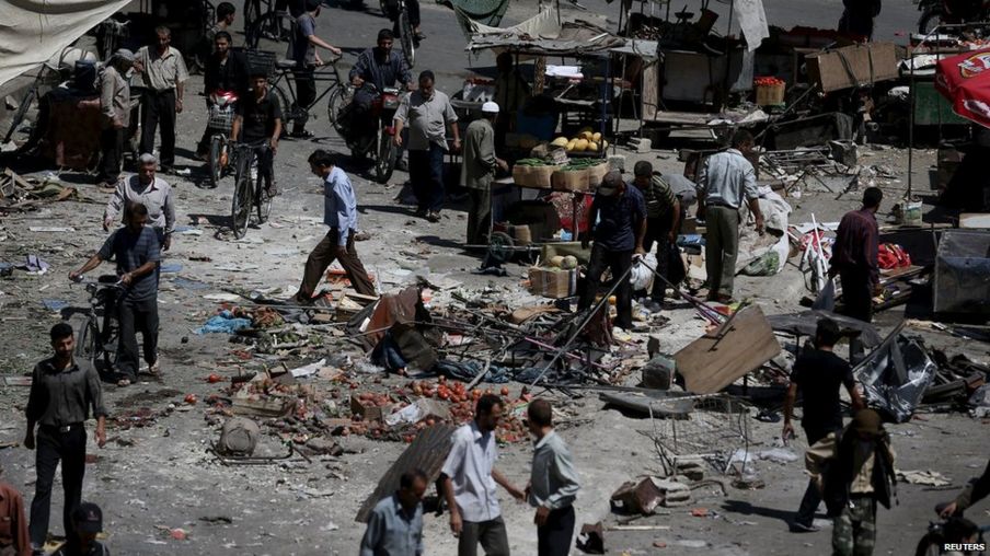People inspect the damage after what activists said were government airstrikes