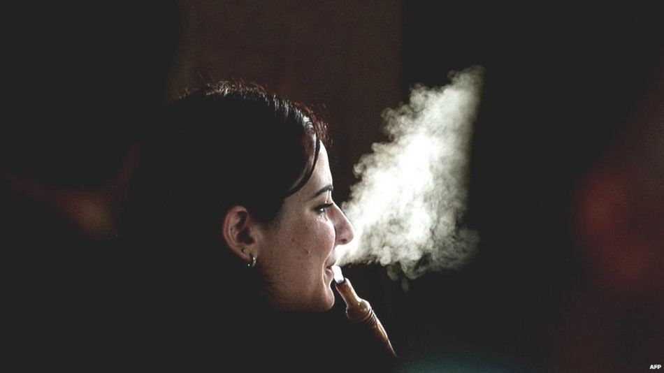 A woman smokes Shisha at a cafe in Dubai on May 31, 2008.