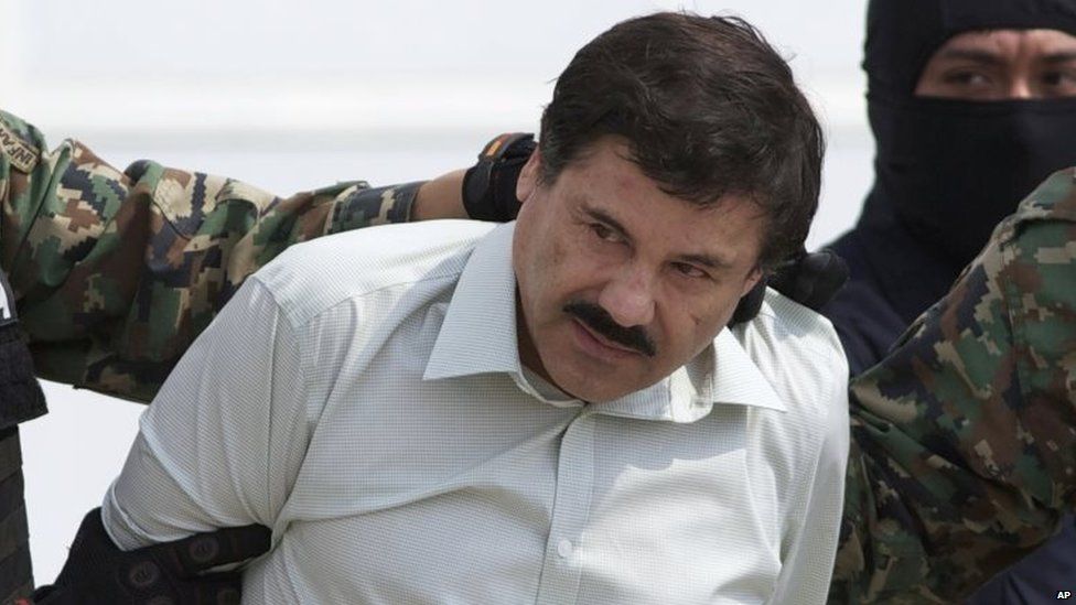 Joaquin "El Chapo" Guzman, head of Mexico's Sinaloa Cartel, is escorted to a helicopter in Mexico City, following his capture overnight in the beach resort town of Mazatlan 22 February 2014