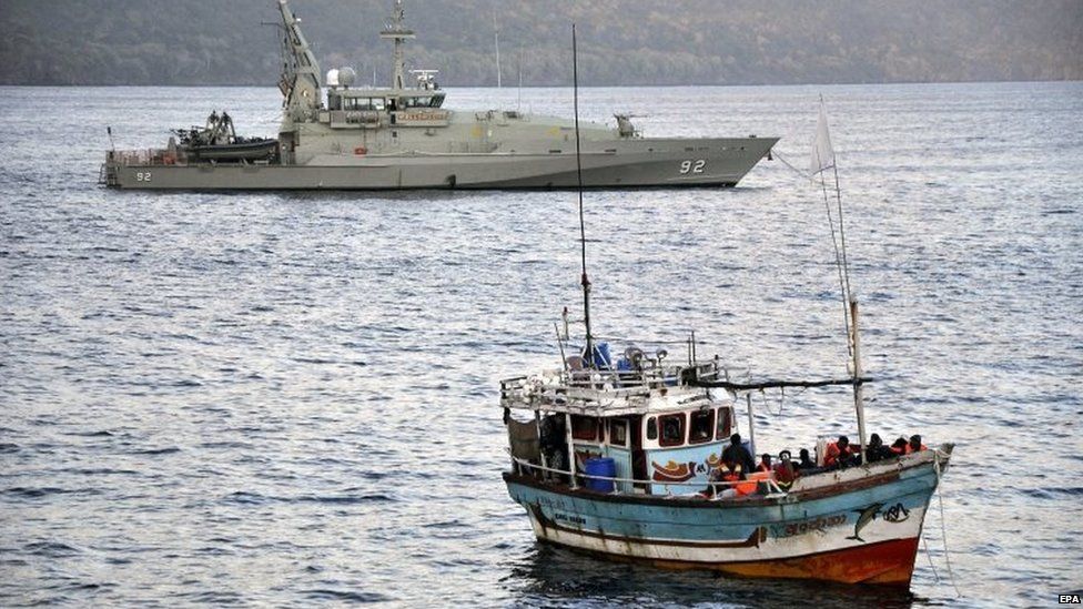 Asylum seekers who arrived by boat escorted by Australian navy patrol boats are moored in Flying Fish Cove, Christmas Island, Australia, 16 August 2012