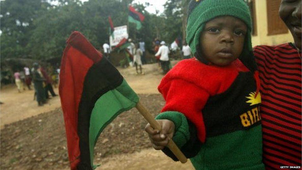 Lucia Ihim carries her nine-month-old sibbling Chidera Ihim, wearing Biafran colors, 19 August 2005 during a rally by the Movement for the Actualisation of Sovereign State of Biafra in Okwe in southeastern Nigeria.