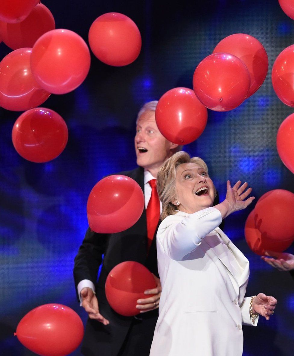 Balloons descend as Democratic presidential nominee Hillary Clinton and former US president Bill Clinton celebrate