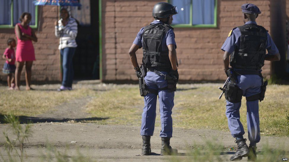South African policemen patrol an area in Rustenburg on April 30, 2014