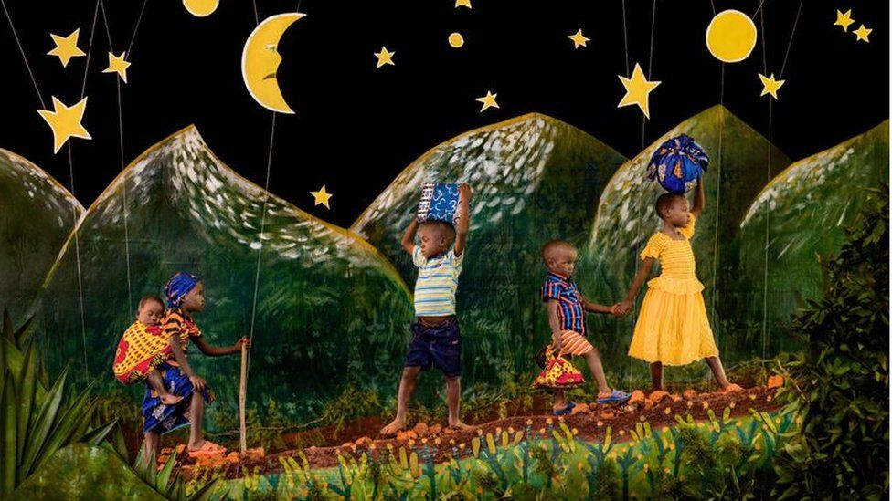 A photograph showing children trekking through hills under a starlit sky depicted as if in a children's story book by Patrick Willocq