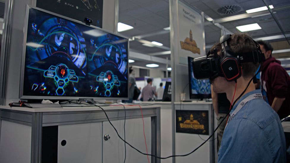 Man looks at screen through virtual reality glasses