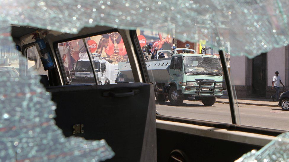 Riot police seen through a broken car window in Harare, Zimbabwe - Wednesday 3 August 2016