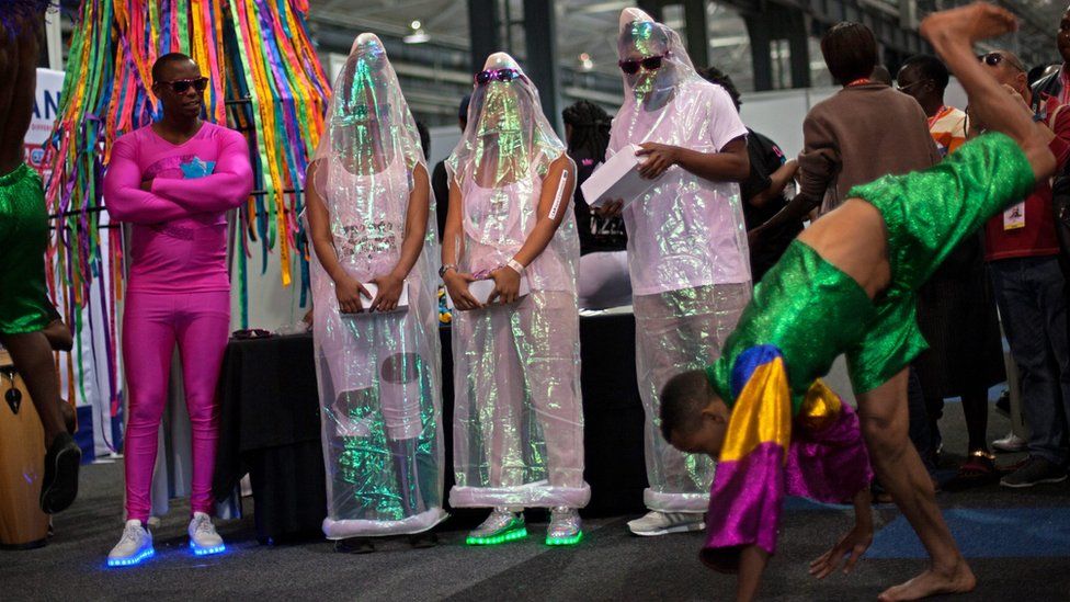 People in man-sized condoms during a performance at the Durban International Conference Centre, in Durban, South Africa - Tuesday 19 July 2016