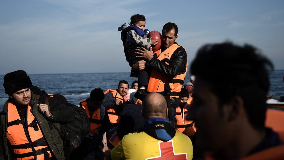 Migrants arrive by boat on the Greek island of Lesbos