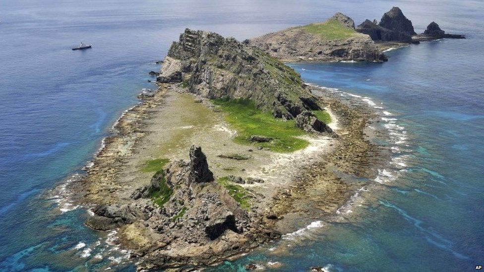 The survey ship Koyo Maru, left, chartered by Tokyo city officials, sails around Minamikojima, foreground, Kitakojima, middle right, and Uotsuri, background, the tiny islands in the East China Sea, called Senkaku in Japanese and Diaoyu in Chinese, Sunday, Sept. 2, 2012.