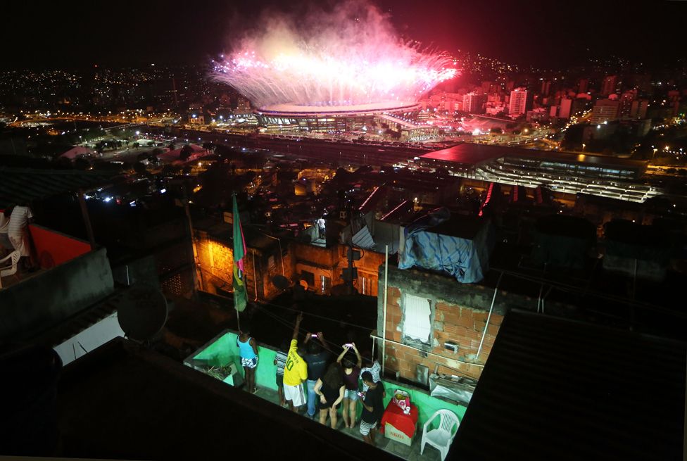 Fireworks explode over Maracana stadium with the Mangueira 'favela' community in the foreground during opening ceremonies for the Rio 2016 Olympic Games on 5 August 2016 in Rio de Janeiro, Brazil.