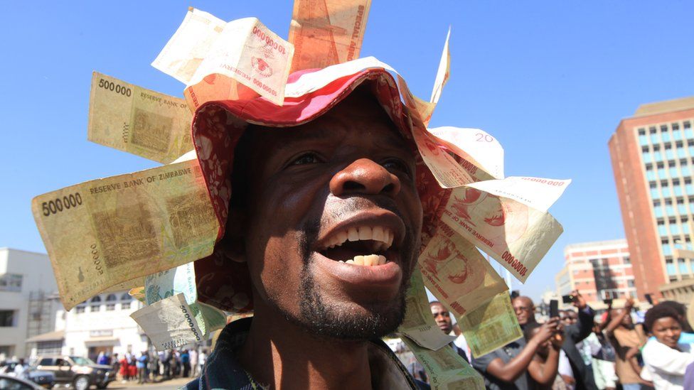 A protester wearing a hat with old Zimbabwe dollar notes attached to it in Harare - Wednesday 3 August 2016