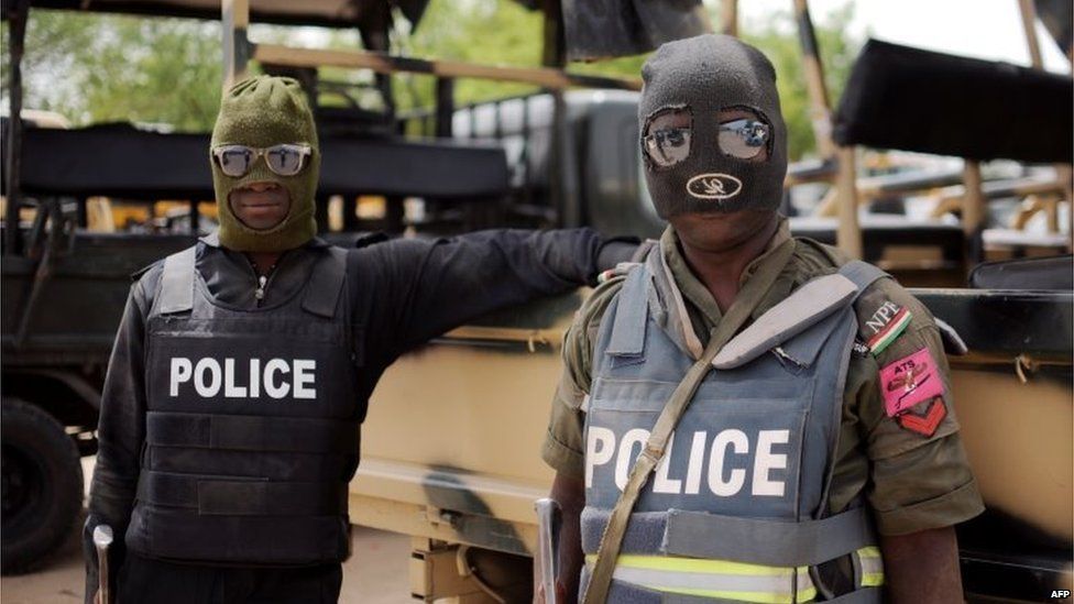 Nigerian police part of the joint forces in Borno state pose prior to a patrol in former Boko Haram headquarters in Maiduguri on June 5, 2013.