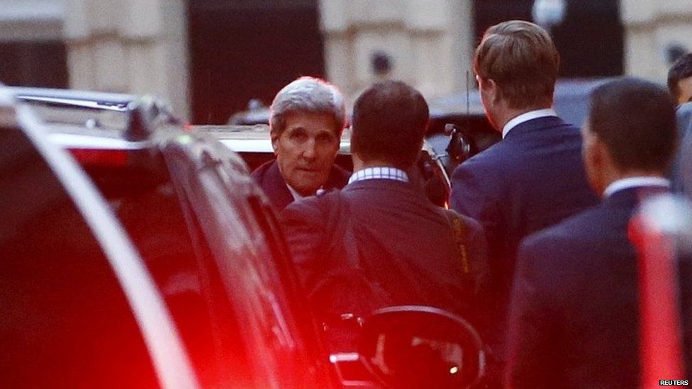 US Secretary of State John Kerry (left) leaves Palais Coburg, the venue for nuclear talks in Vienna (13 July 2015)