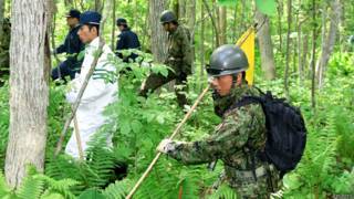 Soldados del ejército japonés buscan a niño perdido en el bosque