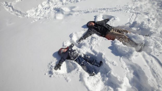 Dos personas juegan en la nieve