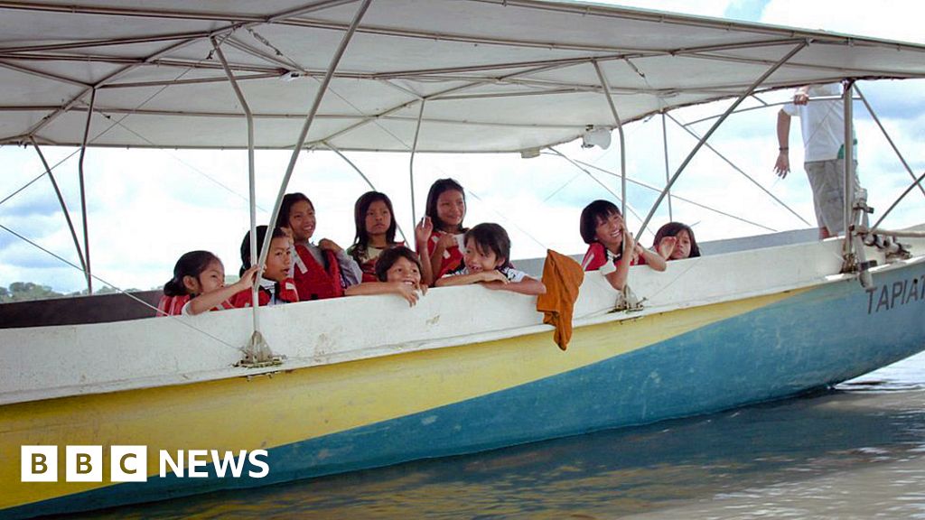 Children on the solar canoe on their way to school