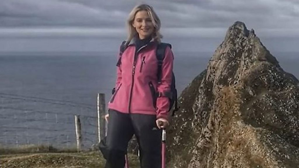 Cancer survivor climbing a mountain using crutches