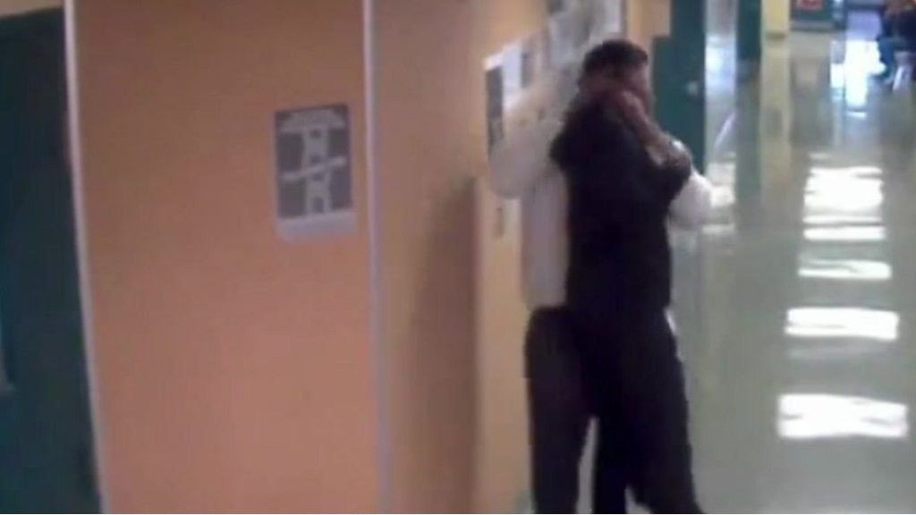 The moment a school employee lifts student by neck