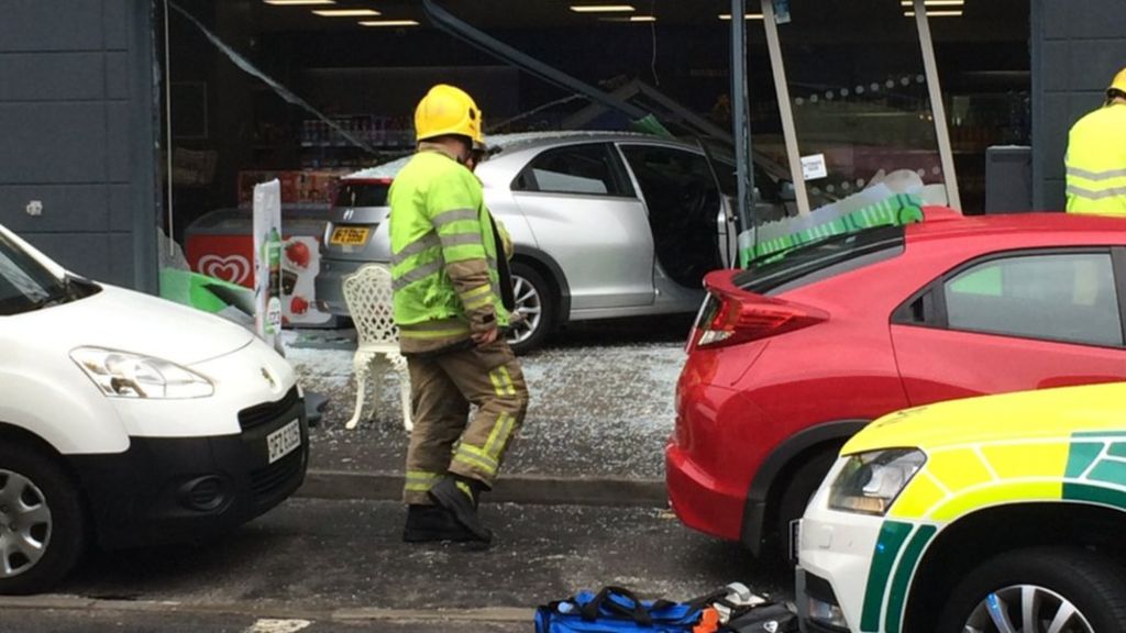 Car crashes into shop window in Belfast - BBC News