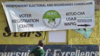 A school boy looks at a banner advertising a voter-registration point January 18, 201