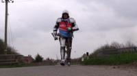 Paul Beddows running in a suit of armour