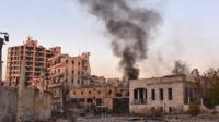 Smoke billows in Aleppo's Bustan al-Basha neighbourhood