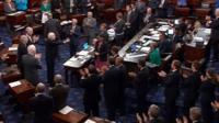 US Senator John McCain (R-AZ), who had been recuperating in Arizona after being diagnosed with brain cancer, acknowledging applause as he arrives on the floor of the U.S. Senate after returning to Washington for a vote on healthcare reform in Washington, US 25 July 2017