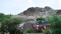 Rubbish dump and a destroyed home