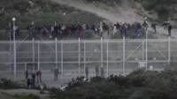 Migrants attempting to reach Europe have stormed the border fence between Morocco and Spain's North African enclave of Ceuta.