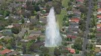 Fountain of water from burst water pipe