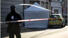 White forensic tent covers scene in London where stabbing victim fell