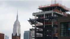 A building under construction is seen in front of the Empire State Building January 30, 2018 in New York