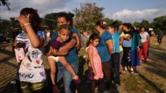 Migrants taking part in the caravan to the US queue for food in Oaxaca, Mexico on Tuesday