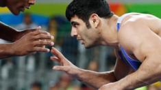 In this file photo taken on August 20, 2016 shows USA's J'den Michael Tbory Cox (red) wrestling with Iran's Alireza Mohammad Karimi Mashiani in their men"s 86kg freestyle quarter-final match during the wrestling event of the Rio 2016 Olympic Games